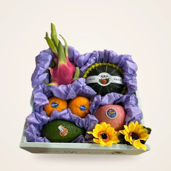 Dragon Fruit & Avocado Gift Tray - dragon fruit, avocado, pumpkin, oranges and apple in purple tissue with sunflowers