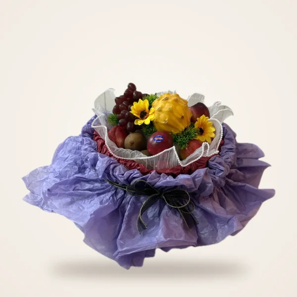Lilac Wrap Hatbox Fruit Basket - grapes, dragon fruit and sunflowers in a round hatbox wrapped in lilac tissue
