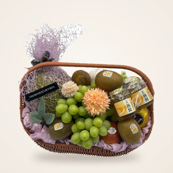 Melon & Grape Oval Fruit Hamper - melon, green grapes, kiwi and flowers in an oval woven hamper