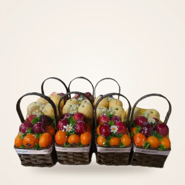 Mini Fruit Gift Baskets - a set of mini woven baskets filled with oranges, apples and pears