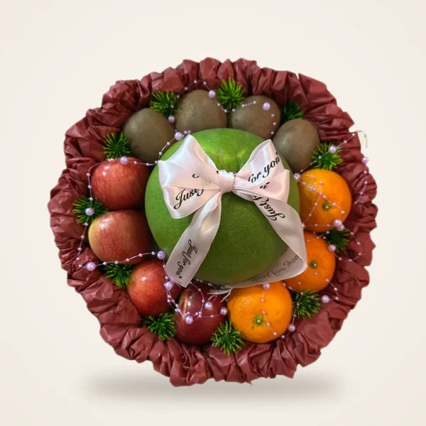 Pomelo & Apple Maroon Ruffle Fruit Basket - pomelo with a bow, apples, kiwi and mandarins in a maroon ruffle basket