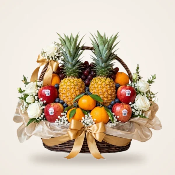 Premium Double Pineapple Fruit Basket - two pineapples, apples, oranges, blueberries and white roses with a gold ribbon