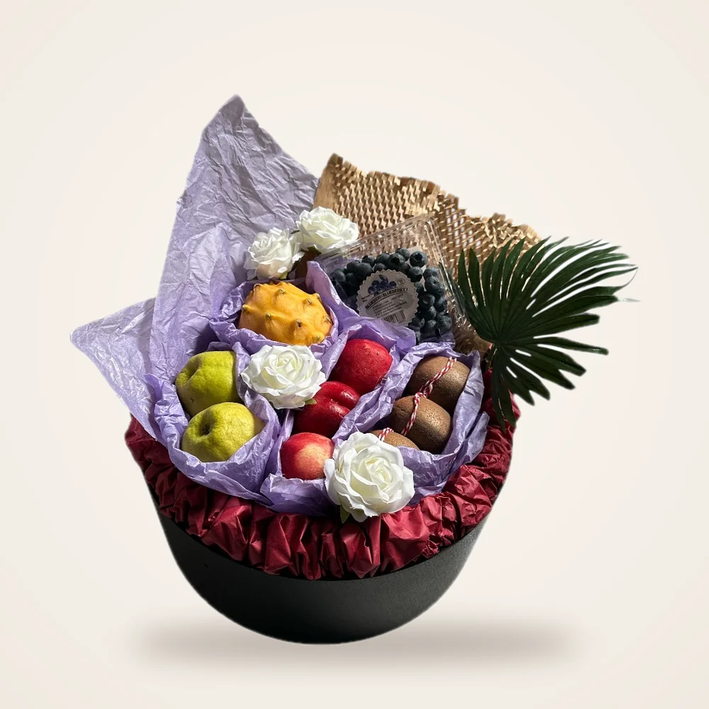 Purple Tissue Hatbox Fruit Basket - dragon fruit, blueberries, apples and white roses in purple tissue on a round hatbox