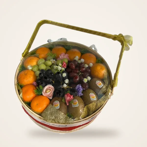 Round Bamboo Fruit Basket with Gold Handle - oranges, grapes, kiwi and roses in a round basket with a clear lid and gold handle