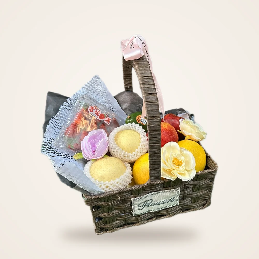 The Serenity Fruit Basket - pears, yellow fruit and roses in a woven 'Flowers' basket with a pink ribbon